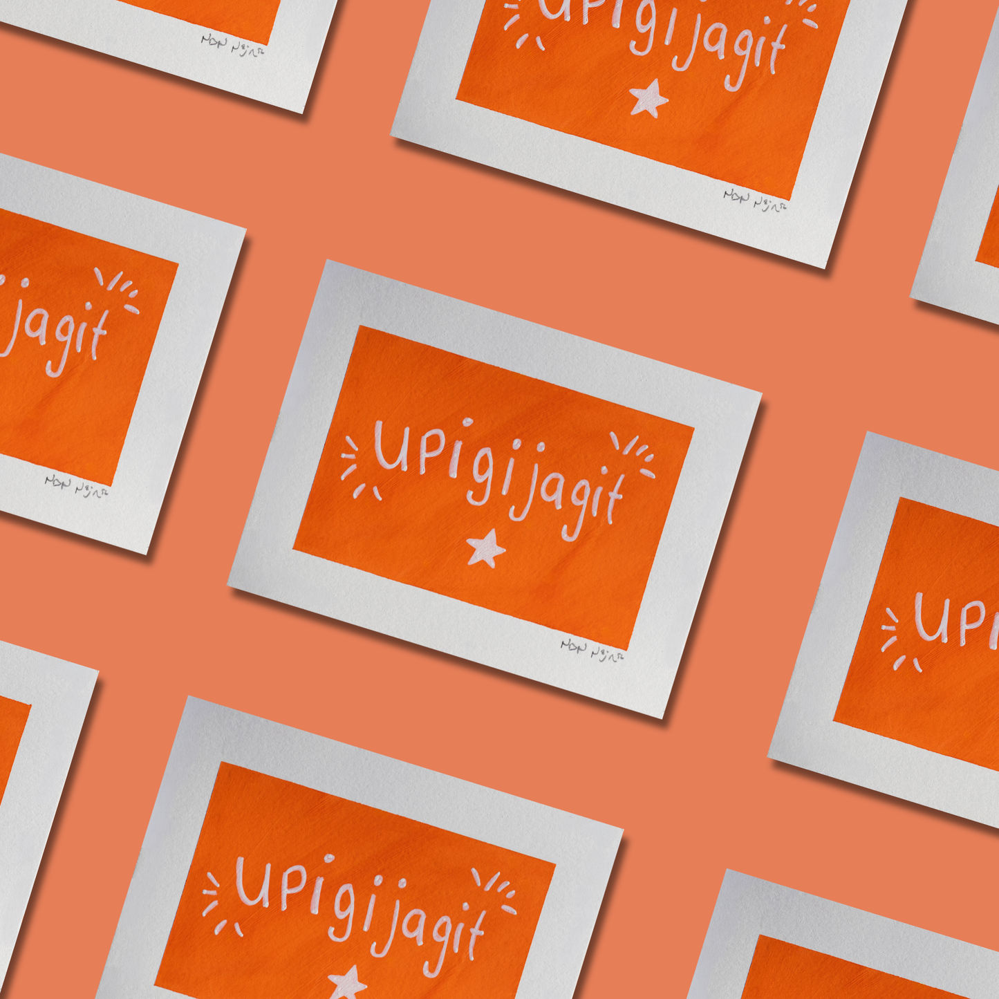 A repeating pattern featuring the hand-painted artwork ‘Upigijagit,’ each piece showing the Inuktitut word meaning ‘I’m proud of you’ in white lettering on a vivid orange background. Each print includes a white border and a small white star beneath the text, with expressive white accent lines surrounding the word. The artworks are arranged diagonally on a soft coral background, creating a bright, uplifting visual rhythm.