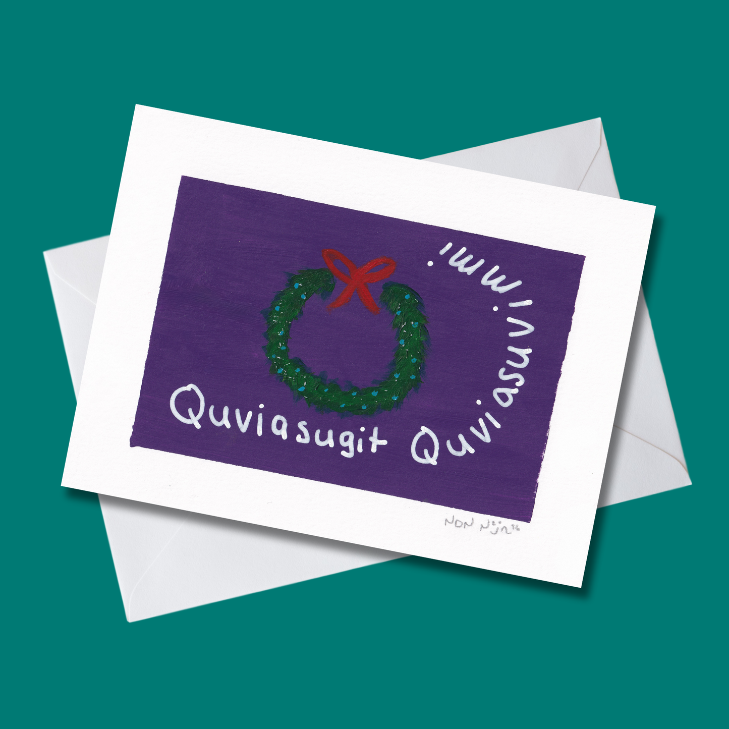 Hand-painted ‘Quviasugit Quviasuvik’ artwork displayed at an angle over a teal background with a white envelope. The piece features a green wreath with a red bow against a deep purple backdrop, surrounded by the Inuktitut phrase ‘Quviasugit Quviasuvik,’ meaning ‘Merry Christmas.’ The composition evokes festive warmth and Northern celebration through rich contrast and gentle brush texture.