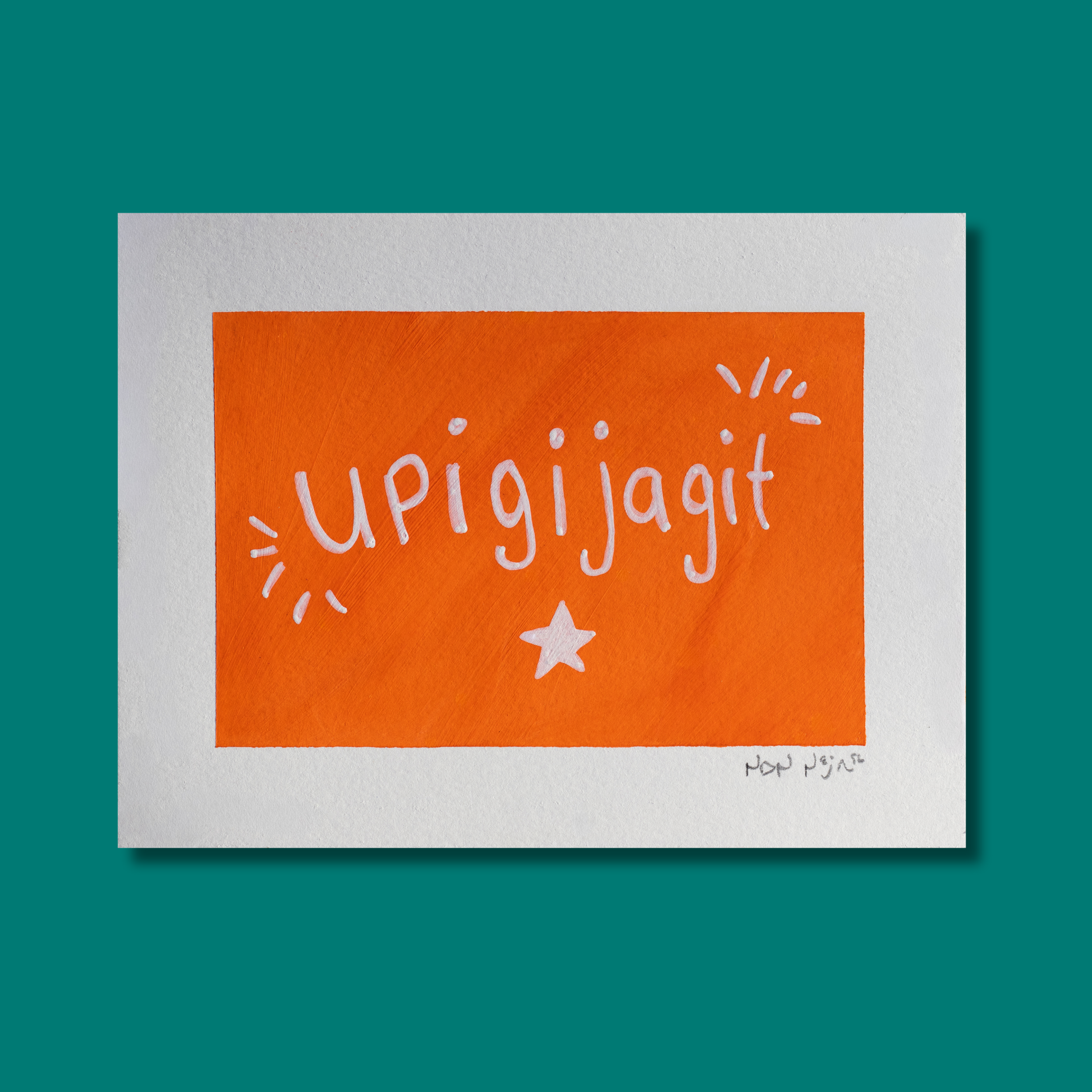 Hand-painted artwork titled ‘Upigijagit,’ featuring the Inuktitut word for ‘I’m proud of you,’ written in playful white lettering across a vivid orange background. Decorative white lines radiate from each side of the text, symbolizing light or joy, with a single white star centered below. The piece rests on a teal background, creating a bold and modern contrast that highlights its uplifting message.