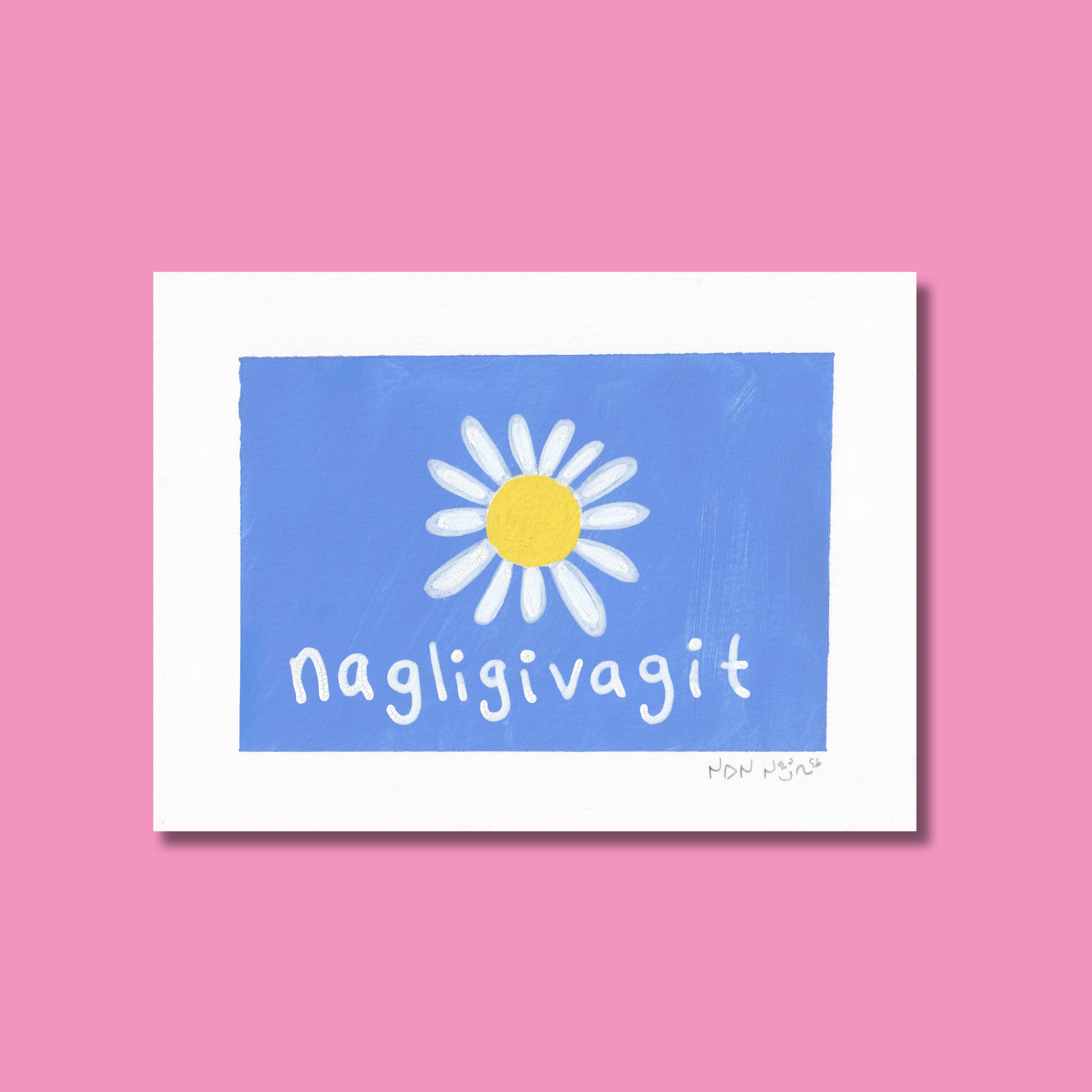 Hand-painted artwork titled ‘Nagligivagit,’ featuring a white daisy with a bright yellow centre on a vivid blue background. The Inuktitut word ‘Nagligivagit,’ meaning ‘I love you,’ is written below in soft white script. The piece is photographed against a pink backdrop, creating a tender, joyful contrast that evokes warmth and affection.
