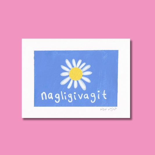 Hand-painted artwork titled ‘Nagligivagit,’ featuring a white daisy with a bright yellow centre on a vivid blue background. The Inuktitut word ‘Nagligivagit,’ meaning ‘I love you,’ is written below in soft white script. The piece is photographed against a pink backdrop, creating a tender, joyful contrast that evokes warmth and affection.