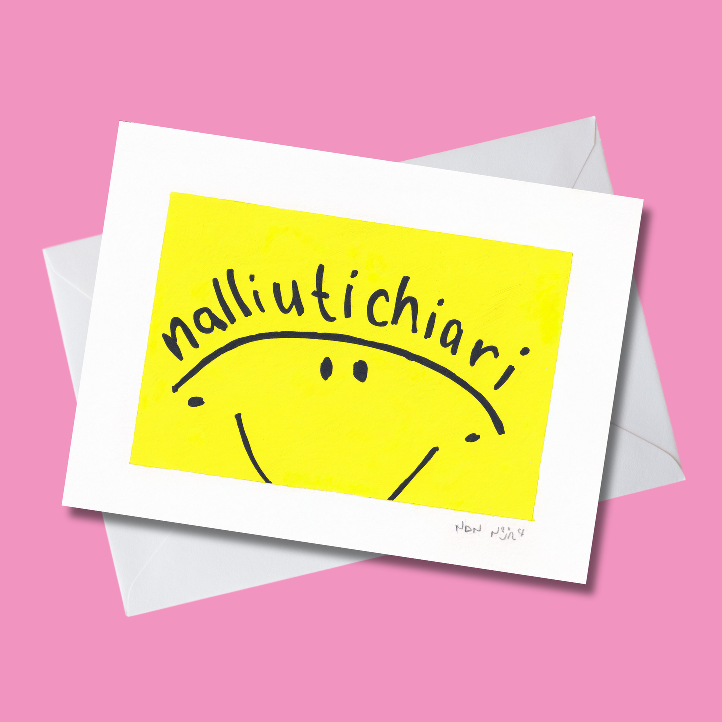 Hand-painted artwork titled ‘Nalliutichiarit,’ featuring a simple black smiley face on a bright yellow background with the Inuktitut word ‘Nalliutichiarit,’ meaning ‘Happy Birthday,’ curved across the top. The piece is photographed at an angle against a soft pink background with white envelope, radiating warmth, joy, and playfulness.